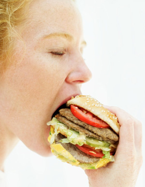 woman eating large burger