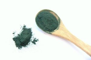 Spirulina powder and wooden spoon