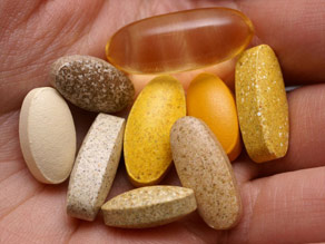 vitamins on persons hand
