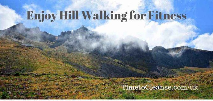 mountains with clouds and a meadow with enjoy hill walking for fitness banner